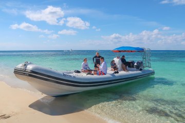 a boat on a beach near a body of water